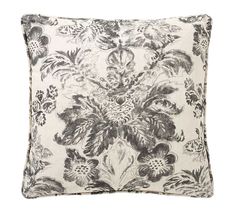 a black and white floral pillow on a white background with an embroidered flower design in the center