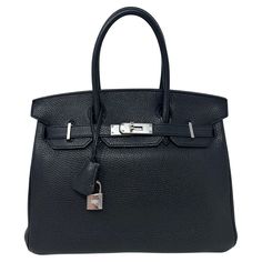 Hermes Black Birkin 30 Bag. Silver palladium hardware. Togo leather. Interior clean. Looks like brand new. Plastic is still on the hardware. Classic black Birkin is an investment. Includes clochette, lock, keys, and dust bag. Guaranteed authentic. Evening Bags With Lock In Epsom Leather, Evening Epsom Leather Bag With Lock, Classic Bags With Metal Hardware For Everyday Luxury, Timeless Everyday Luxury Bag With Lock, Classic Travel Bag With Lock, Timeless Travel Bags With Lock, Luxury Bags With Silver-tone Hardware In Epsom Leather, Evening Bags With Epsom Leather And Turn-lock Closure, Evening Bags With Turn-lock Closure In Epsom Leather