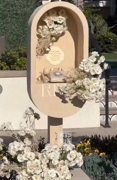 a memorial with flowers on it and a sign in the background