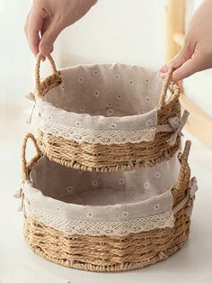 three baskets are stacked on top of each other with lace trimming around the edges