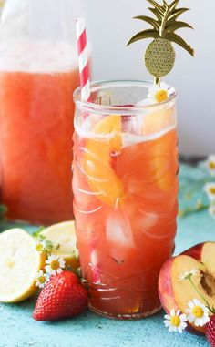 a mason jar filled with fruit and topped with a straw