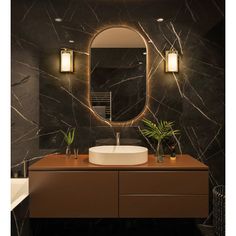 a bathroom with a sink, mirror and plants on the counter in front of it