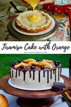 a cake with orange icing on top and chocolate sauce drizzled over it