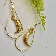 Handmade gold-tone half moon earrings with ear wire closure. I found these vintage charms and wanted to make them into a more dynamic earring! Moons measure 1" long and total drop of earring is 2.25". Perfect with any outfit! Brass Teardrop Earrings With Moon Charm, Celestial Gold Dangle Hoop Earrings, Teardrop Brass Earrings With Moon Charm, Gold Half Moon Celestial Earrings, Gold Moon Shaped Metal Hoop Earrings, Gold Moon-shaped Metal Hoop Earrings, Gold Half Moon Hoop Earrings With Moon Charm, Gold Teardrop Earrings With Moon Charm, Gold Half Moon Earrings With Moon Charm