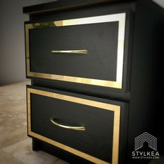 a black and gold dresser with two drawers