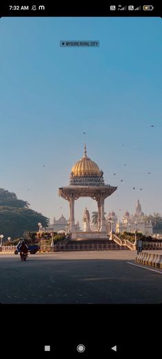 an image of a gazebo in the middle of a road with birds flying around