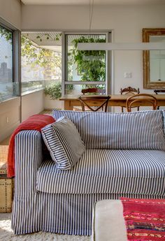 a striped couch sitting in front of a wooden table