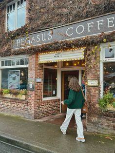 a woman walking out of a coffee shop