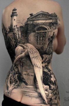 the back of a woman's body is covered in tattoos and features an image of a lighthouse