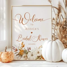 a welcome sign with white pumpkins and greenery in the foreground, along with other fall decorations