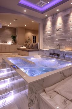 an indoor jacuzzi tub is lit up with blue lights in the bathroom area