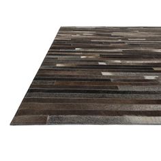 an area rug with different colors and patterns on it, including brown, black, gray and white stripes