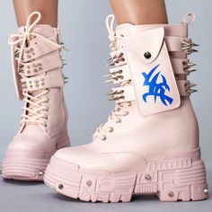 Adds A Touch Of Daring Confidence To Your Rebellious Style When Rocking In The Anthony Wang X Wtf Cv Chem Baby Metal Pink Platform Boots. This Striking Rave Festival Boots Features Pastel Pink Colored Vegan Leather Upper With Lace-Up Front, Triple Spiked Buckle Strap Details, Side Pocket With Tribal Symbol Accents, Built-In Inner Wedge Heel, And Chunky Platform Rubber Outsole With Spikes. Now, Let Your Footwear Do The Talking. #Smirk -Wtf Cv Chem Baby Metal Pink Platform Boots -4" Heel, 1.75" Pl Anthony Wang Shoes, Pink Platform Boots, Festival Boots, Brown Combat Boots, Womens Duck Boots, Pink Platform, Baby Metal, Pink Platforms, Waterproof Snow Boots