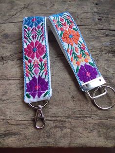 a pair of key fobs with flowers on them