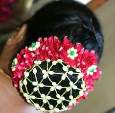 a close up of a woman's head with flowers on it and hair comb