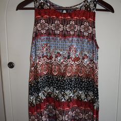 Clearance! No Additional Discounts Accepted! Gypsies & Moondust Tunic Top Size: S Material: 100% Rayon (Has Some Stretch) Color: Multicolored Shades Of Blue, Brown, Red, Black, White, Golden Tan Pattern: Paisley, Floral Sleeveless Curved Hem Peep-Hole Back Yolk W/Button Closure Scoop Neck Approx. 25 1/2" L. X 16.5" Pit To Pit Cute Top! Great For Summer! Patterned Sleeveless Printed Tank Top, Bohemian Stretch Sleeveless Tank Top, Bohemian Flowy Sleeveless Tank Top, Flowy Bohemian Sleeveless Tank Top, Multicolor Flowy Sleeveless Top, Flowy Sleeveless Tops For Festivals, Multicolor Sleeveless Boho Print Top, Bohemian Multicolor Sleeveless Tank Top, Sleeveless Boho Print Top For Festival