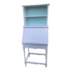 a white desk with a blue shelf on top