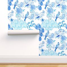 a blue and white wallpaper with birds on it