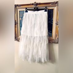 Measurement Xl Waist 32 Inches Length 35 Inches Measurement Size Large Waist 29 Inches Length 34 Inches Measurement Medium Waist 28 Inches Length 34 Inches Add A Touch Of Elegance To Your Outfit With This Beautiful White Tulle Skirt. The Ruffled Tiered Waist Adds A Feminine And Classic Touch To The Solid Pattern Design. The Pull On Closure Makes It Easy To Wear And The Mid-Rise Waistline Flatters All Body Types. Perfect For Any Occasion, Whether It Be A Party, Casual Day Out, Or A Formal Event. Chic Spring Skirt With Attached Cancan, Spring Flowy Skirt With Attached Cancan, Elegant Spring Tiered Petticoat, Elegant Summer Petticoat With Ruffled Skirt, Elegant Ruffled Petticoat For Summer, Elegant Summer Ruffled Petticoat, Elegant Summer Tiered Petticoat, Spring Full Skirt With Attached Cancan, Elegant Ruffled Skirt Petticoat For Spring