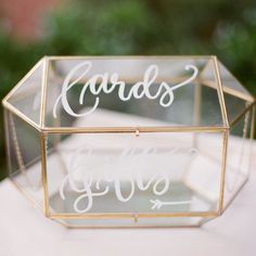 a clear box with the word cards on it sitting on top of a white table