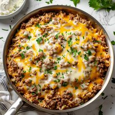 a casserole dish filled with ground beef and cheese