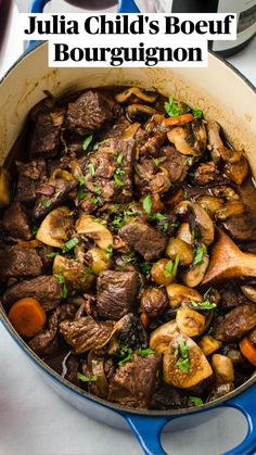 a pot filled with beef and mushrooms on top of a table