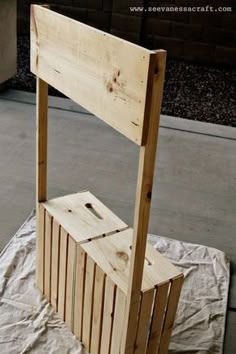 a wooden chair sitting on top of a white sheet