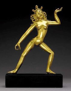 a gold statue is shown on a black stand with its arms outstretched and legs spread out