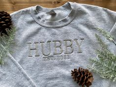 "HUBBY EST. DATE EMBROIDERED APPAREL ♡ Gildan 18000 Heavy Blend Crewneck Sweatshirt T - Unisex ♡ Wifey Established Date ♡ 100% Pre-Shrunk Cotton ♡ 40/50 Cotton/Polyester ♡ Made in the U.S. IMPORTANT NOTICE: Crewnecks now have a paper like stabilizer that appears on the inside. This helps with increasing quality and ensure a longer lasting design on the sweatshirts. Please message Kewteepie if a larger size is needed and we will check on sizes available for accommodation. ADD INITIALS TO YOUR SLE Embroidered Apparel, Letter Sweatshirt, Embroidered Crewneck, L And Light, Embroidered Clothes, Custom Sweatshirts, Custom Initials, Custom Letters, Clothing Size Chart