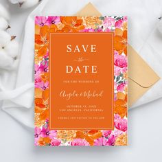 an orange and pink floral save the date card