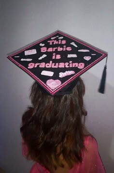 a woman wearing a graduation cap with writing on it