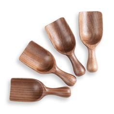 three wooden spoons and one spatula on a white background