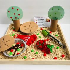 a wooden tray filled with fake trees and other items