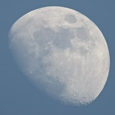 the moon is in the blue sky and it appears to be half - full or half - empty