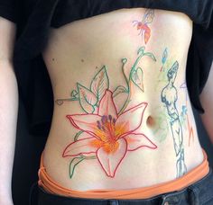 a woman with tattoos on her stomach has a flower painted on the side of her belly