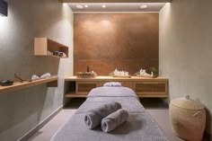 a spa room with towels on the bed