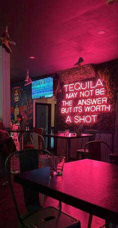 there is a neon sign on the wall in this restaurant