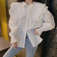 Long sleeve blouse with an oversized peter pan collar with frilly edges. Double layers. Frilly elastic cuffs. 100% polyester S: 18.5" across shoulders, 40" chest, 25" length M: 19" across shoulders, 41.5" chest, 25.5" length L: 19.5" across shoulders, 43" chest, 26" length XL: 20" across shoulders, 44.5" chest, 26.5" length