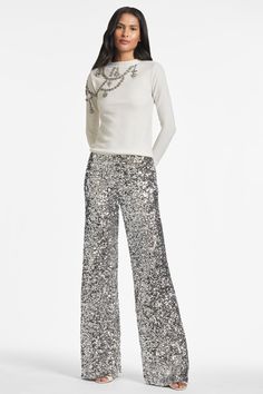 How can you say no to a shimmering and chic sequin trouser? Before you think that you can only dress these up, remember fashion is a feeling and if you want to wear these with a sweatshirt you can! This pant is the party, they upgrade every look and they are absolutely timeless. Plus, there is hidden stretch elastic at the back, so they are comfortable too!Details:Model is 5'11" wearing size 2 31" Inseam Side ZipperAll-Over Sequins ImportedStyle #F221P10-040 Silver Sequin Pants, Creating Clothes, Sachin And Babi, Sequin Pant, Latest Clothing Trends, Ball Skirt, Sequin Pants, Silver Sequin, Black Cocktail Dress