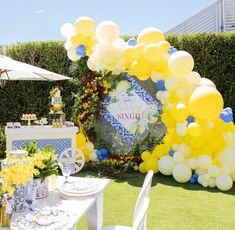 an outdoor party setup with balloons and decorations