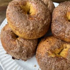 four doughnuts sitting on top of a paper plate