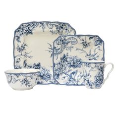 a blue and white dinner set with flowers on it