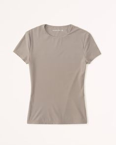 Women's Soft Matte Seamless Tuckable Baby Tee | Women's Tops | Abercrombie.com Seamless Second-skin Short Sleeve Tops, Compressive Solid Color Crew Neck T-shirt, Compressive Crew Neck T-shirt, Solid Compressive Crew Neck T-shirt, Casual Second-skin Short Sleeve Top, Everyday Solid Seamless T-shirt, Seamless Short Sleeve T-shirt With Minimal Stretch, Solid Short Sleeve Seamless Stretch Top, Compressive Solid Summer Tops