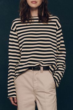 Inspired by a 19th-century nautical uniform, The Sailor Sweater is spun from lightweight cotton yarn. It features a boxy, relaxed fit, wide raw edge boatneck, two-color horizontal stripes, and a longer length. Perfectly slouchy, roll the sleeves and tuck it into your favorite jeans. 100% Cotton Dry Clean Only Wear with The Era Skirt | Black Stripe Long Sleeve Outfit, Nautical Uniform, Striped Long Sleeve Outfit, Formal Dress Jacket, Sailor Sweater, Long Sleeve Outfits, The Sailor, Horizontal Stripes, Straight Leg Denim