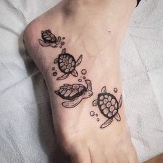 a small foot tattoo with two turtles on it