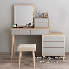 an empty dressing table with a mirror and stool next to it on a hard wood floor