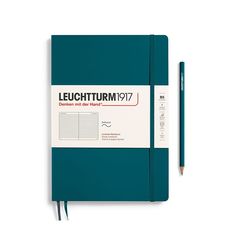 the leuchturm notebook is lined with blue paper and has a pencil in it