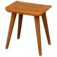 a small wooden stool sitting on top of a white floor