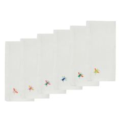 six white napkins with small colorful bugs on the front and back of each one