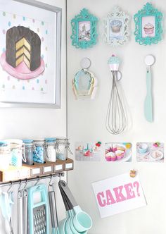 there are many items hanging on the wall in this room, including cupcakes